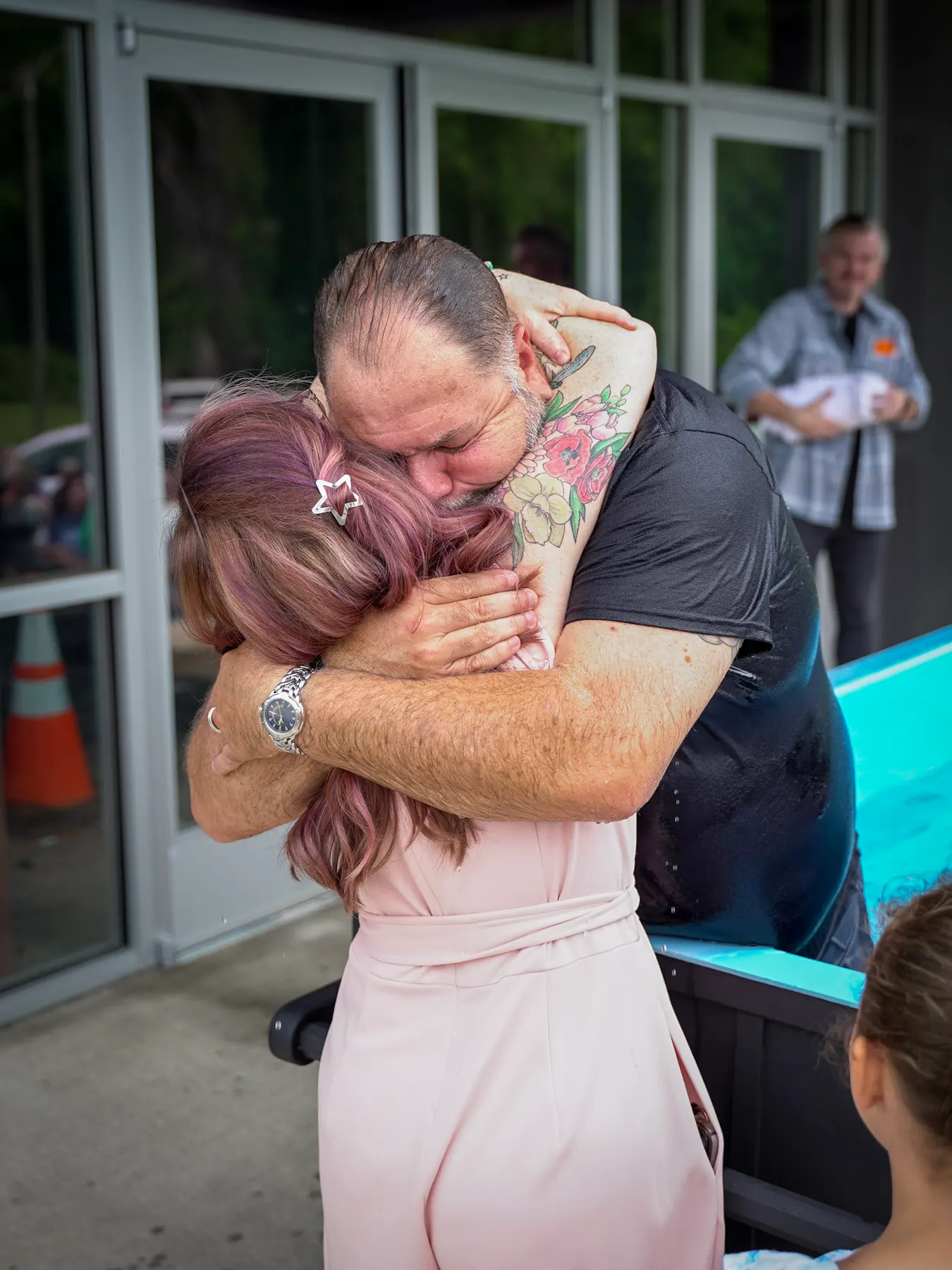 A baptism, and the embrace after it